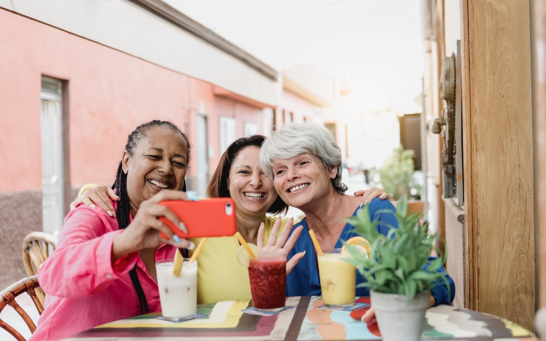 a group of women smiling and sitting at a table