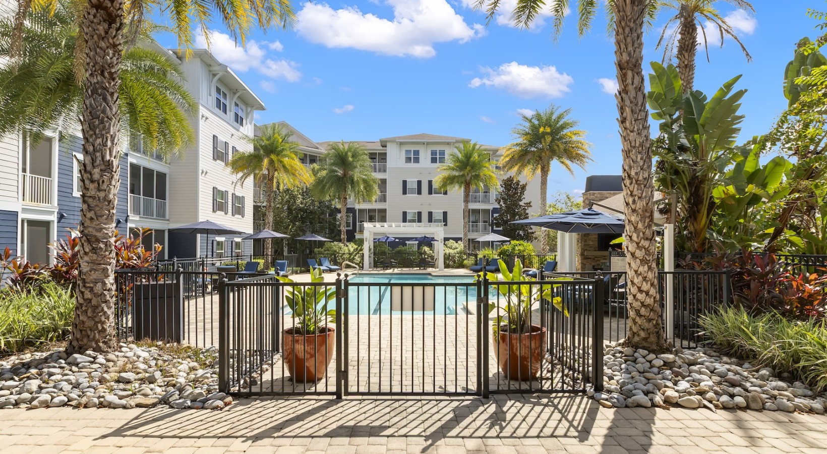 Shimmering resort-style pool Resort-style swimming pool with lounge seating