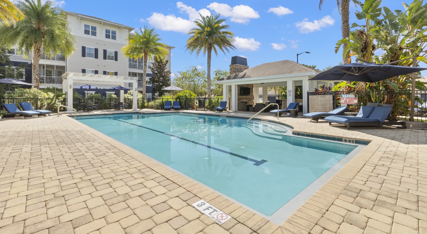 Relax and unwind poolside Resort-style swimming pool with lounge seating