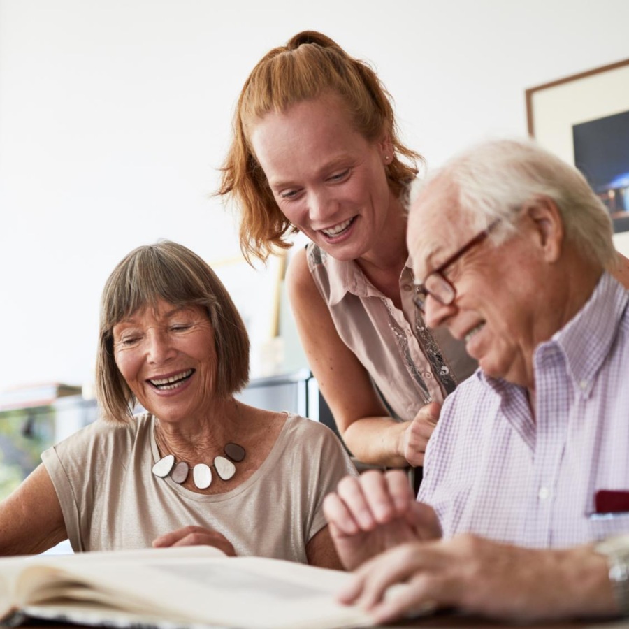 a group of people looking at a book