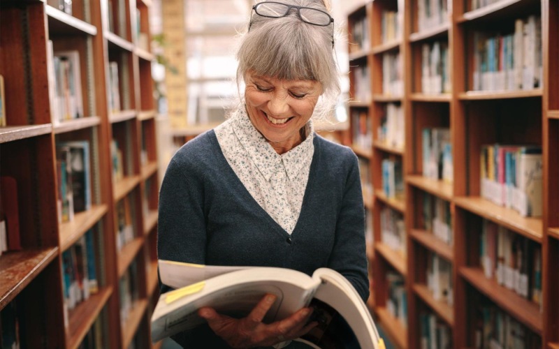 The essence of exceptional living a woman reading a book in a library