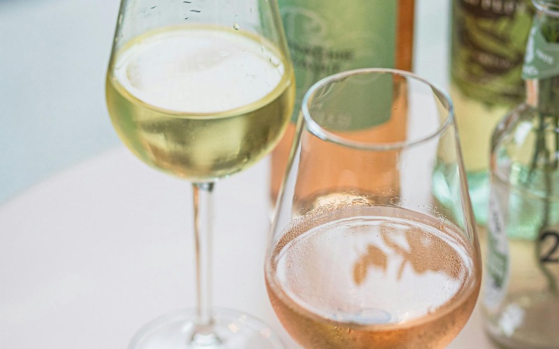 a bottle of wine next to a glass of wine