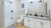 bathroom with a large mirror sink toilet and shower