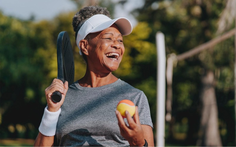 State-of-the-art amenities a woman holding a racket and a ball
