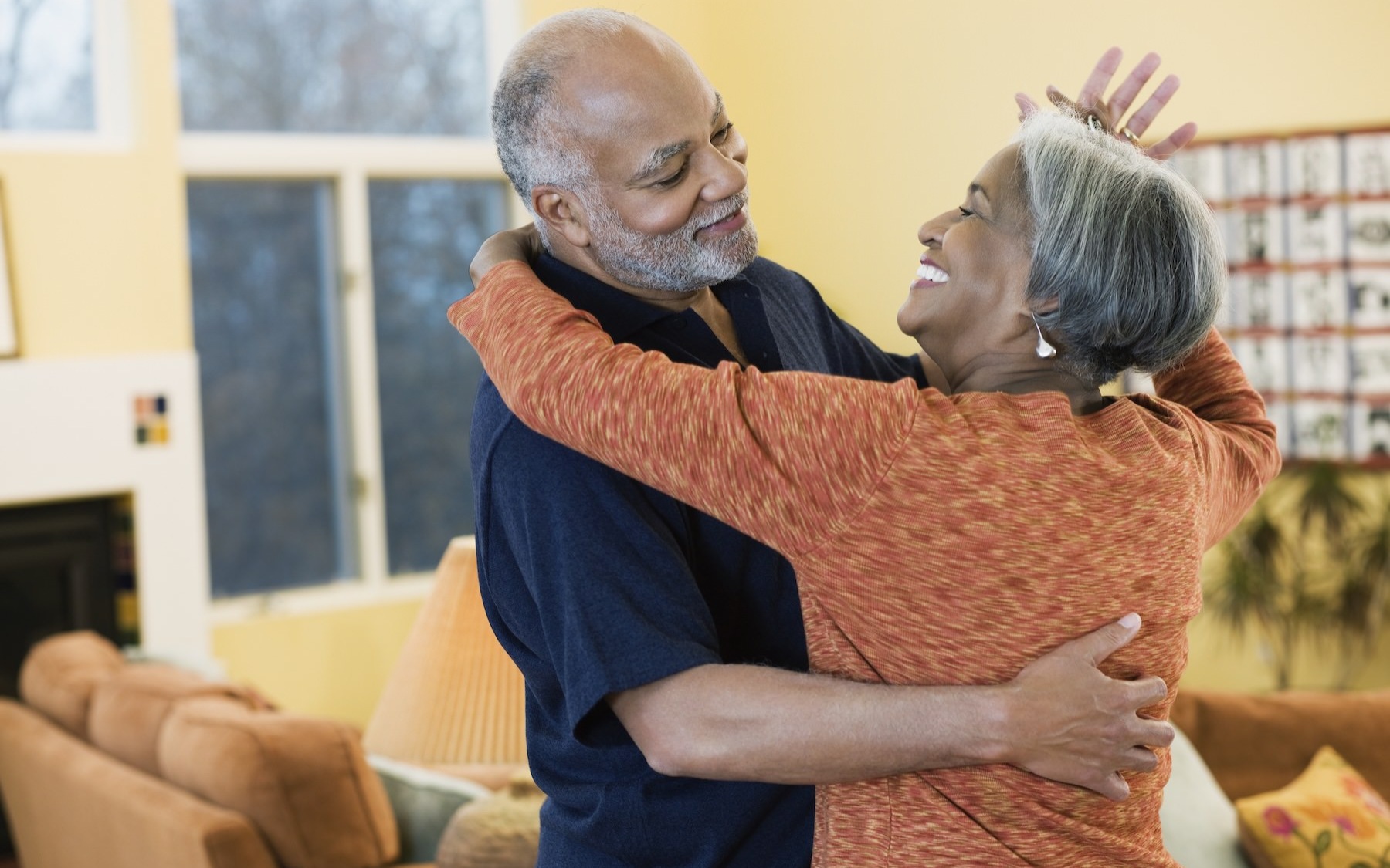 a couple dancing and smiling at each other