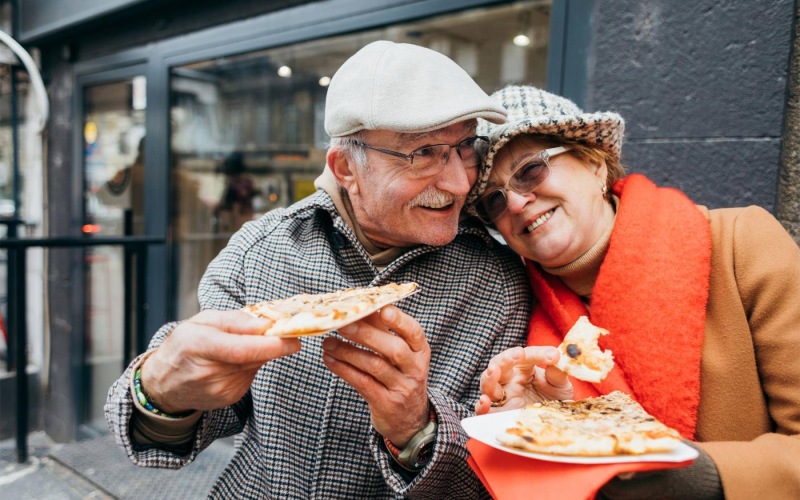 a couple eating pizza