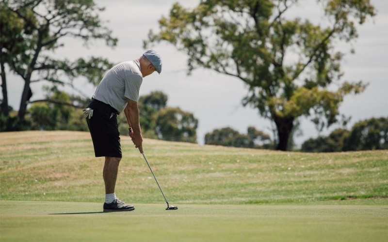 Close to the center of everything a man playing golf