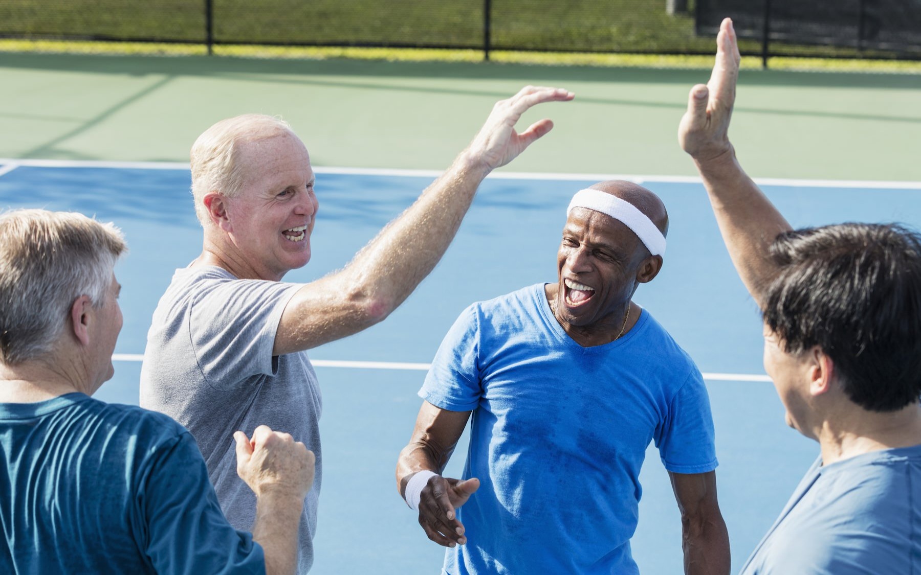 The essence of exceptional living a group of people on a tennis court smiling