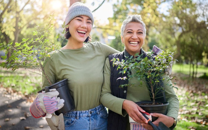 a couple of women holding plants
