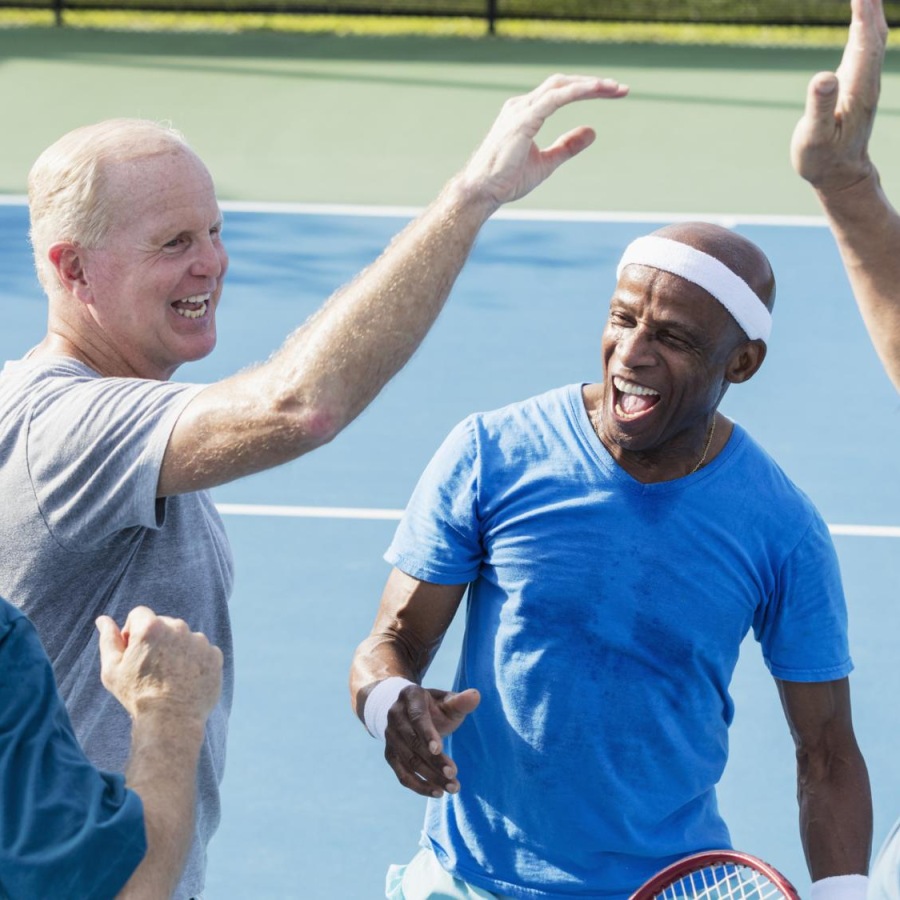 a group of men in a tennis court
