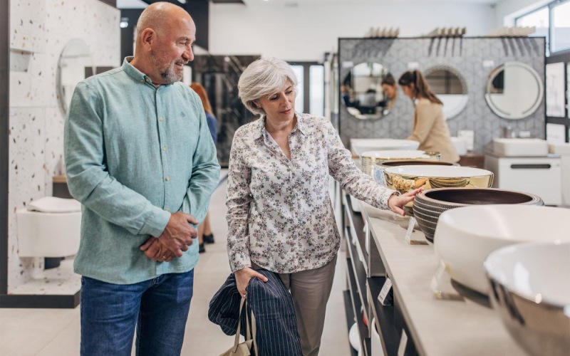 a man and woman shopping for dishes