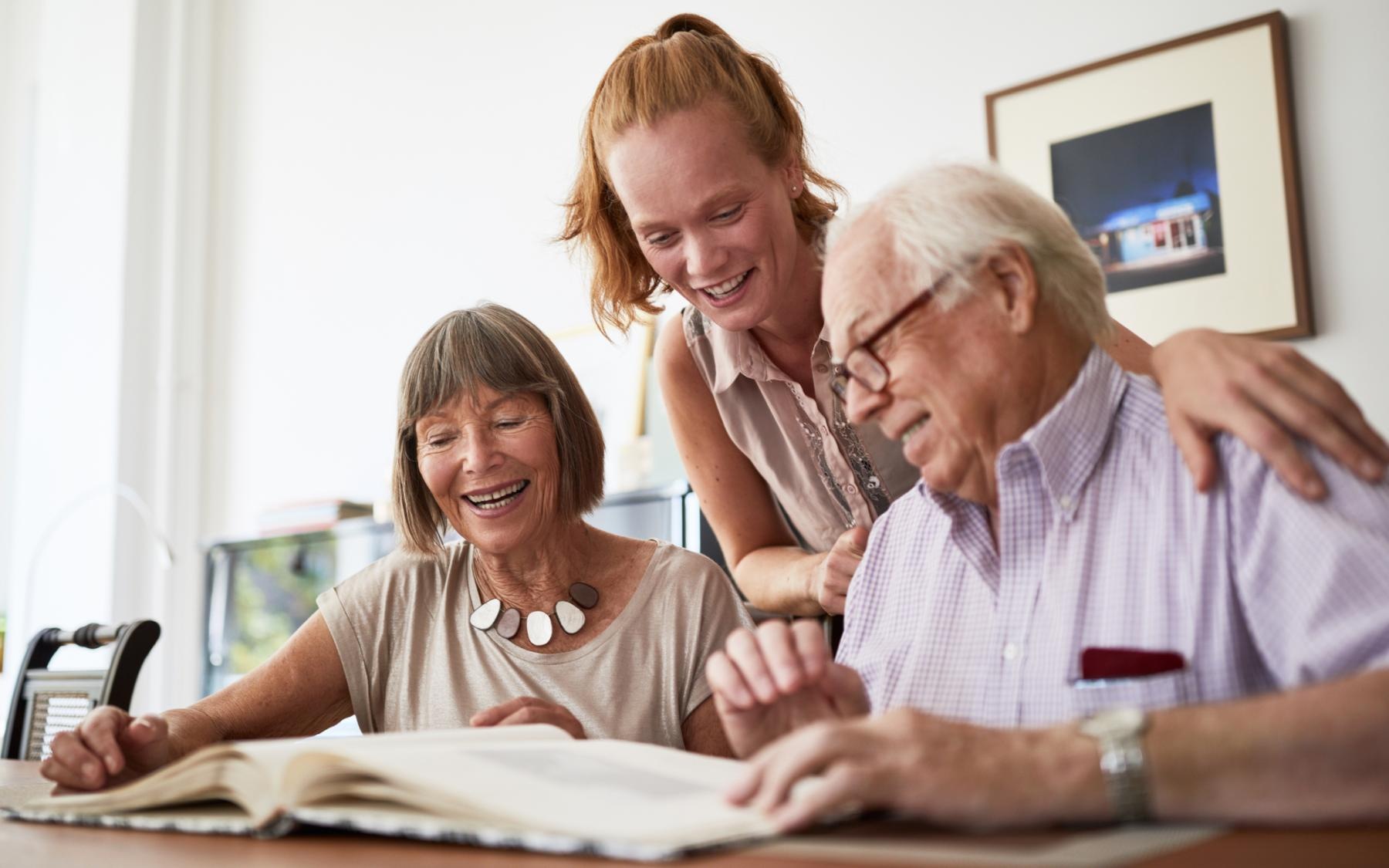 a group of people looking at a book