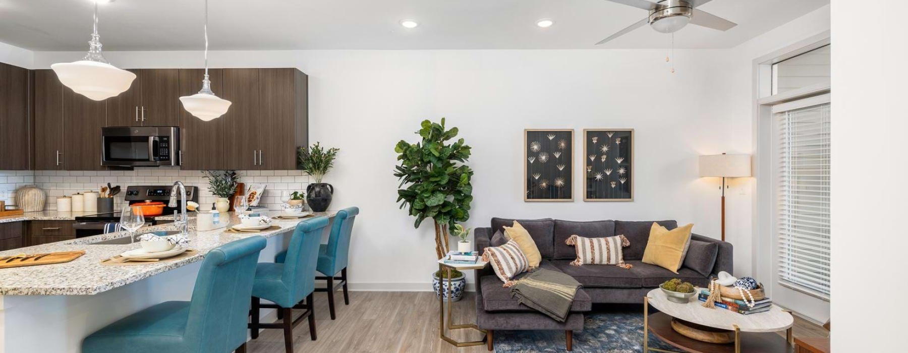 Furnished model living room and kitchen at Album Huntersville active adult community in North Carolina.
