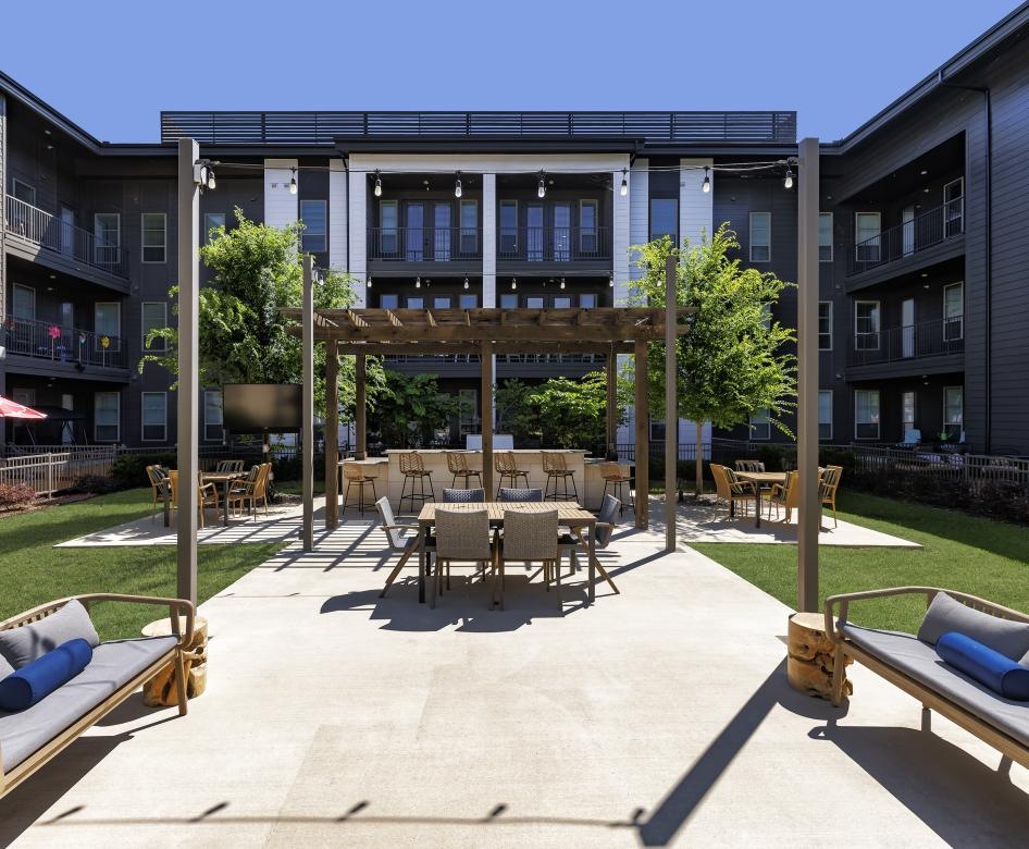 a patio with tables and chairs outside of a building