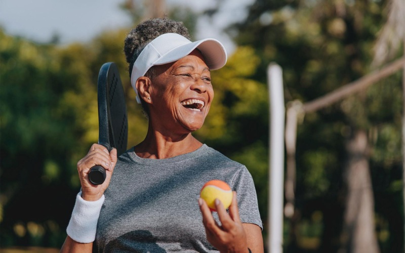 State-of-the-art amenities a woman holding a racket and a ball
