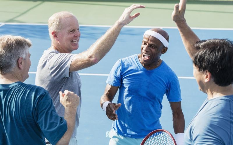 a group of men in a tennis court