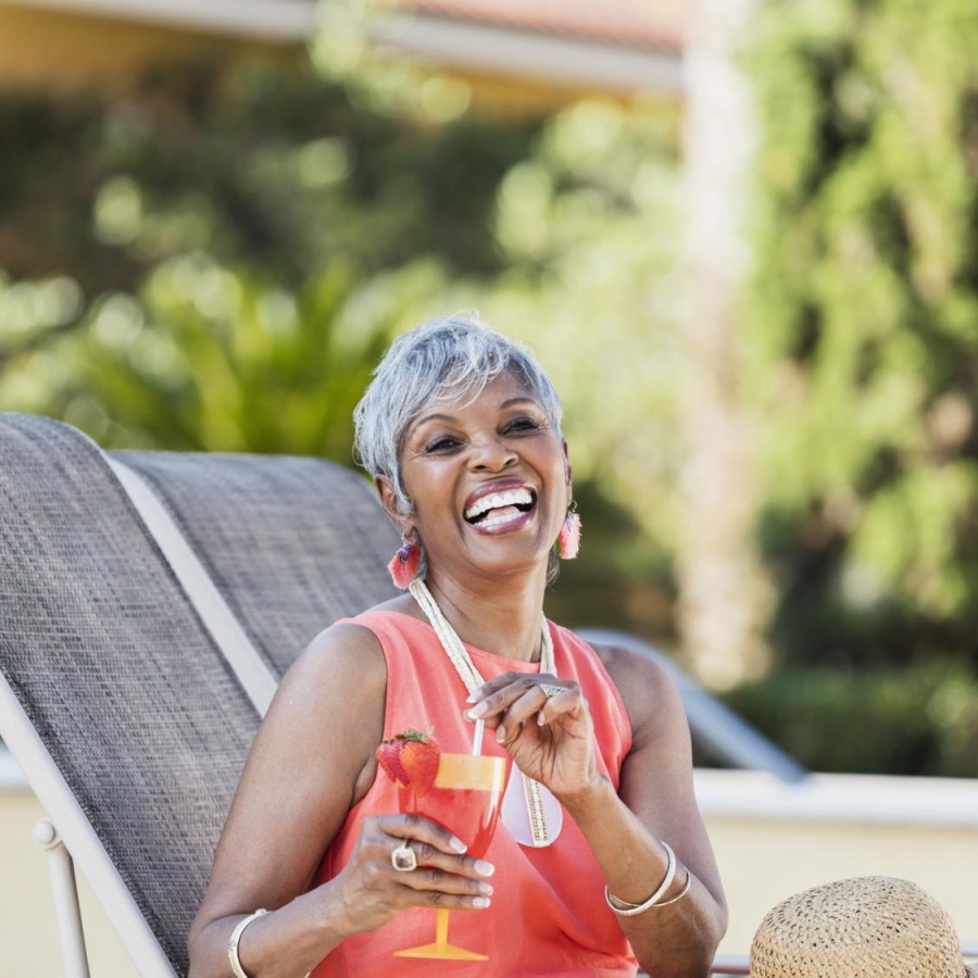 a person sitting on a chair with a glass