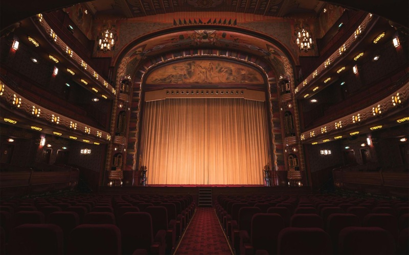 Your new favorite social area a theater with a stage and chairs