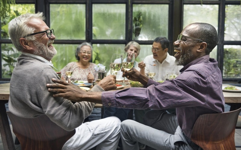 a group of people sitting at a table drinking wine