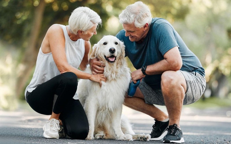We're a pet-friendly community a man and woman petting a dog