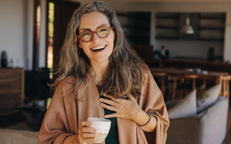 Settle into comfort at Album Summit Pines a woman holding a cup