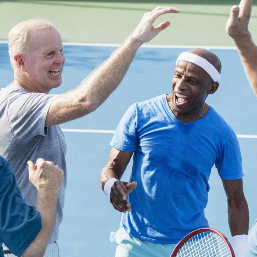 a group of men in a tennis court