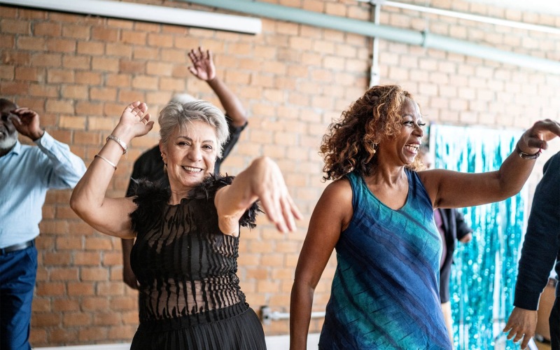 people smiling and dancing together