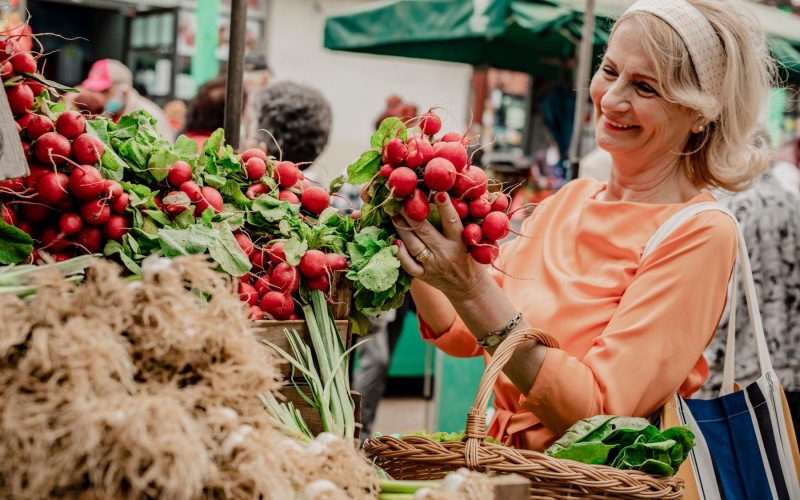 a woman holding a basket of strawberries