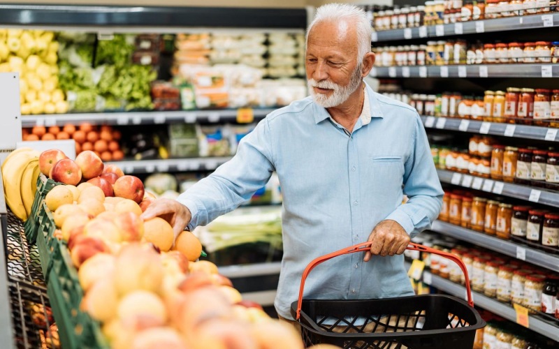 a person holding a shopping cart in a grocery store