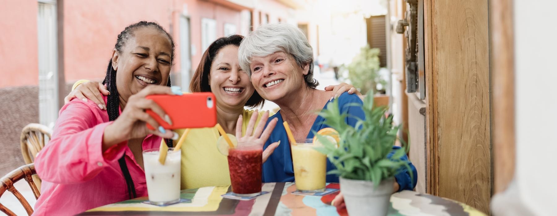 a group of women smiling and sitting at a table