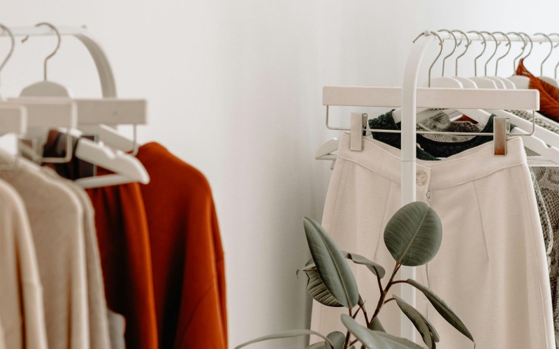 Vibrant community life with a variety of shopping options clothes on a rack near a plant