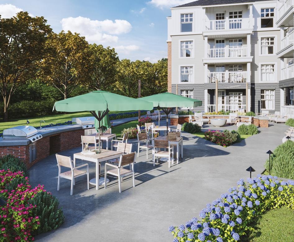 a courtyard with tables and chairs and umbrellas and a building