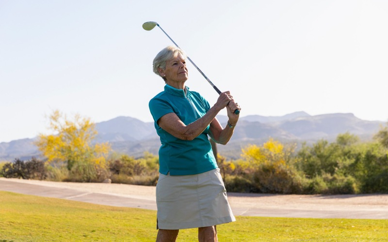 an older woman playing golf