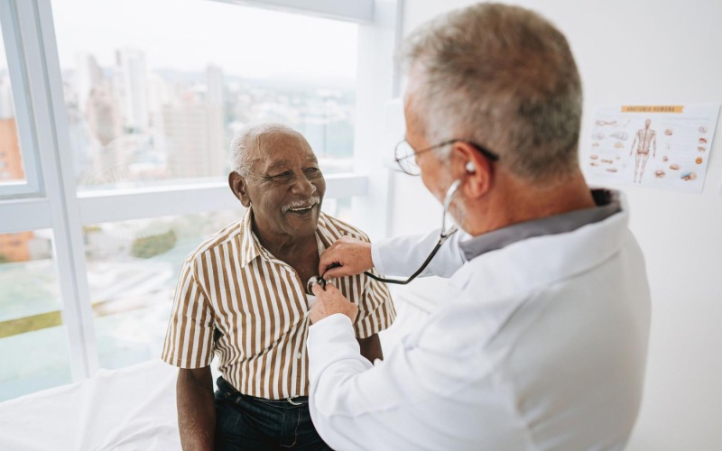 The essence of exceptional living a doctor checking a older man's heart
