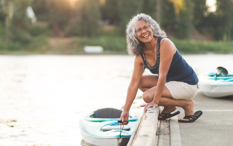 a woman docking a kayak