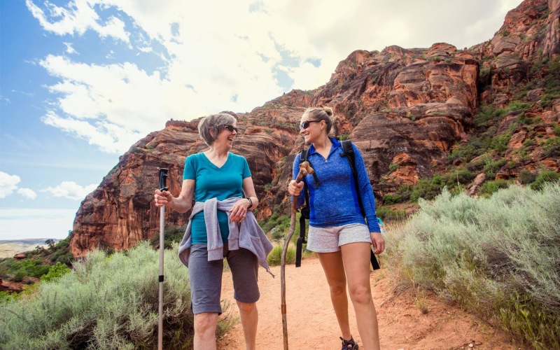 Find your perfect fit at Album Union Village a couple of women walking on a trail with a mountain in the background