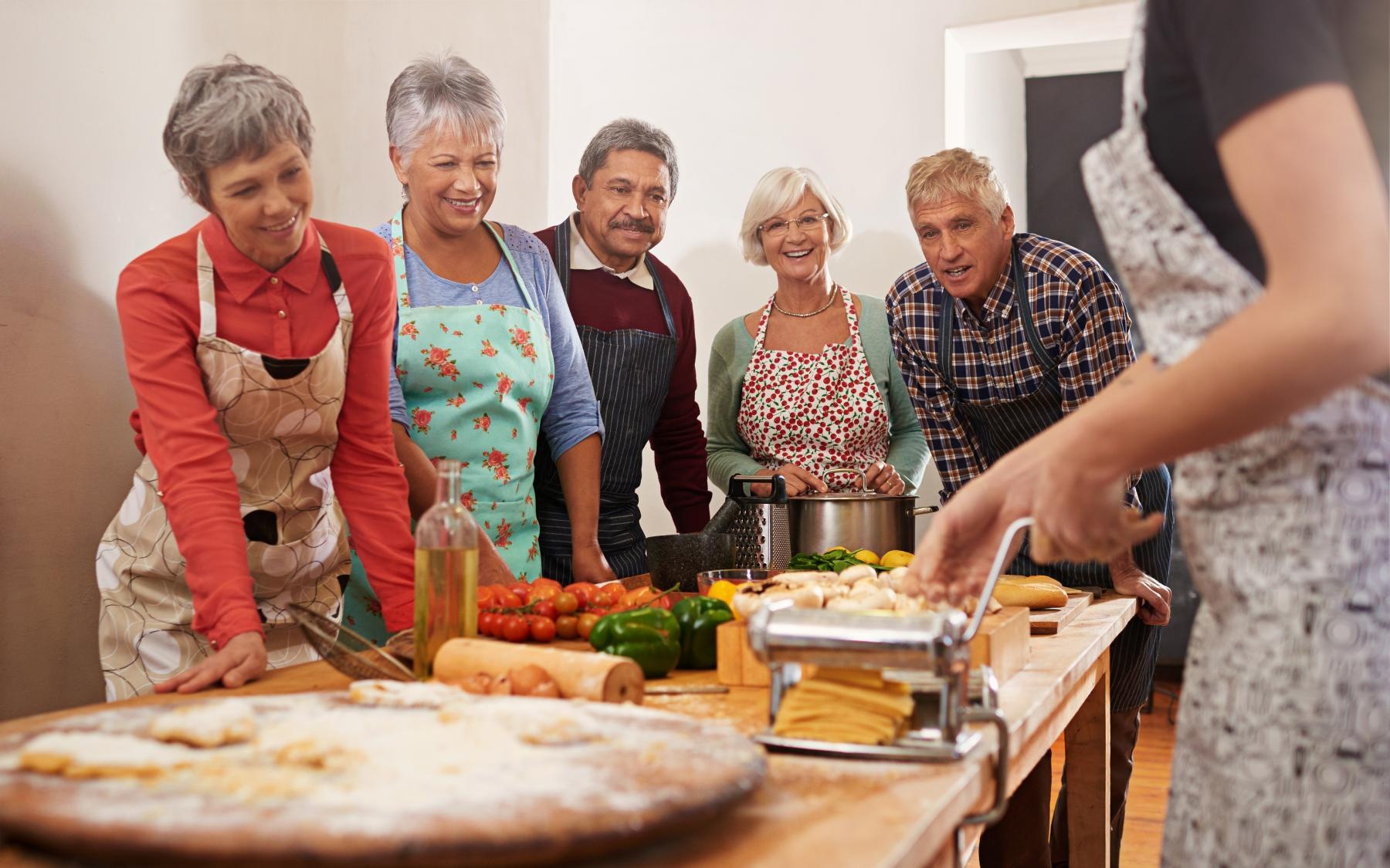 Bustling community with plenty of dining choices a group of people standing around a table with food on it