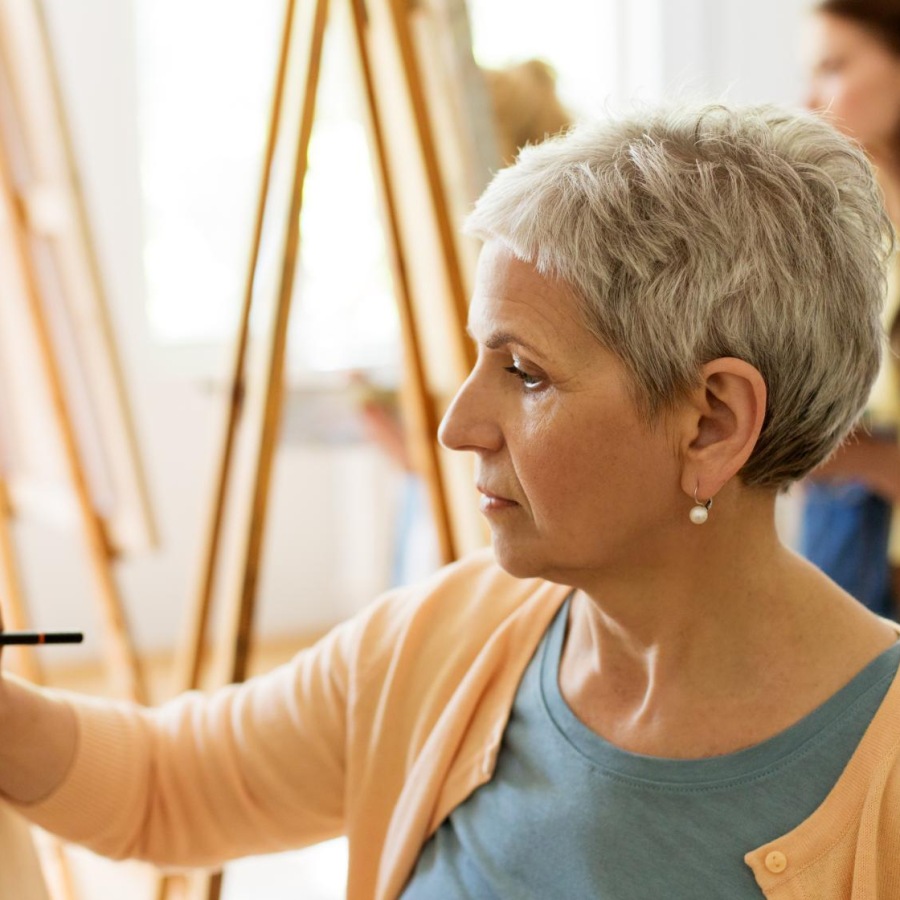 Settle into comfort at Album Marana a person painting a picture